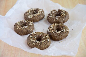 Vegan gluten free bagels topped with sunflower seeds, flax seeds and sesame seeds. Healthy breakfast food. 