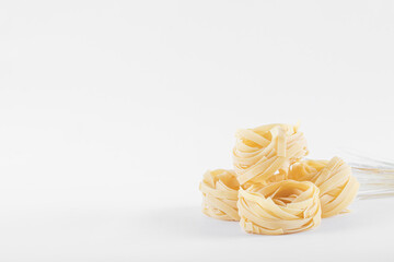 Home made pasta on white background, angle view, soft light, copy space