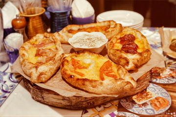Greek pide pastry on restaurant table, toned