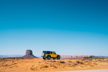 Sport utility vehicle driving off road in Monument Valley