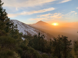 Sunset in the National Park of Teide one winter day. The sun disappears behind the mass of the volcano. Tenerife, Canary Islands