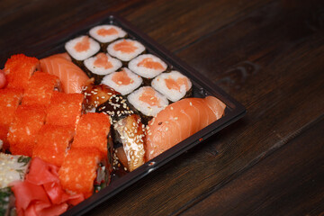 sushi rolls on a wooden table seafood fish filling Wasabi ginger