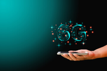 Mobile phone data technology and telecommunication global network concept. Hand-holding mobile or smartphone with low polygon dot connect line shape of 6G on dark background.