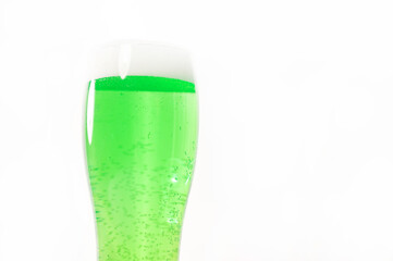 A pint of green beer for st patrick's day on a white background. Traditional Irish drink for a holiday