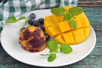 Homemade mango blueberry sorbet garnish with mint leaf