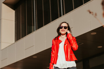 Fototapeta premium Woman talking on the phone outdoors