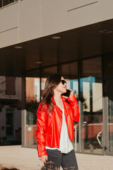 Fototapeta premium Woman talking on the phone outdoors