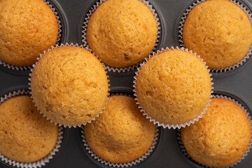 flatley muffins made from white flour, freshly baked. Lie in a baking dish. pattern of cupcakes. confectionery texture concept. High quality photo