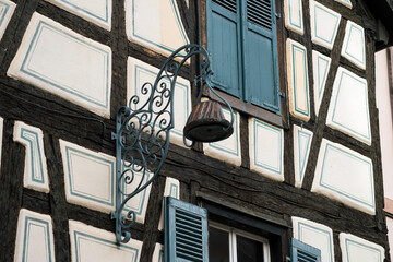 Ribauville - France - 18 February 2021  - retail of traditional alsatian facades of medieval store in a french village with a store retro sign of kougelhopf