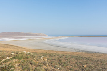 Fototapeta na wymiar Koyash pink lake in the Crimea in the summer. Amazing delicate pastel landscape. The concept of relaxation, tranquility, and peace. Natural background in light neutral shades for design, layouts.