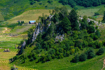 Fototapeta na wymiar view from the hill with the green valley and the hollow rocks without trees