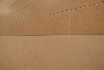 Close-up decorative element of the interior - ceramic tiles on the beige color wall