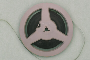 Round film reel. Gray bobbin close-up. The concept of watching an old movie. Family archive