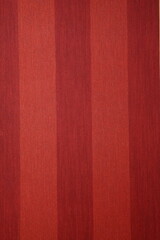 Close-up of a decorative element of the interior of a room - wallpaper: red striped background