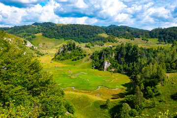 view from the hill with the green valley and the hollow rocks without trees