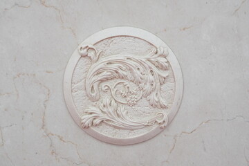 Close-up of a decorative element of the interior of the room - white plaster moldings on white...