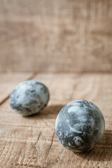 A group of Easter eggs on a brown wooden surface. Frame, border. Copy Space