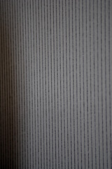 Obraz premium Close-up of a decorative element of the interior of the room - gray striped wallpaper. Can be used as background