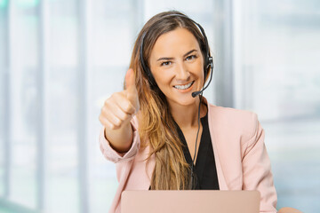  Female customer support operator with headset and smiling.