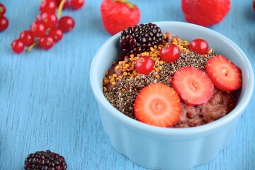 Chocolate oatmeal porridge with strawberry, blackberry, red currant, hemp seeds and flax seeds
