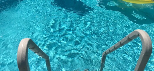 Clear blue pool water with stairs
