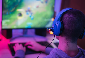 Young gamer playing online video games while streaming on social media - Youth people addicted to...
