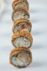 Crispy hot sushi rolls isolated on a white background