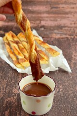Cinnamon sugar puff pastry sticks with chocolate sauce dip