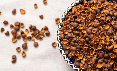 A bowl of brown Siberian pine nut skins. 