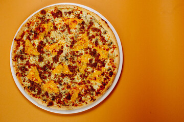 Top view pizza with mushrooms and tomatoes on a green-red background