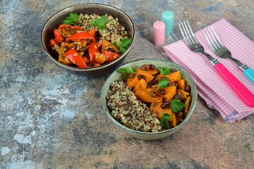Cooked quinoa with roasted sweet potato, bell pepper and raisin. Garnish with parsley