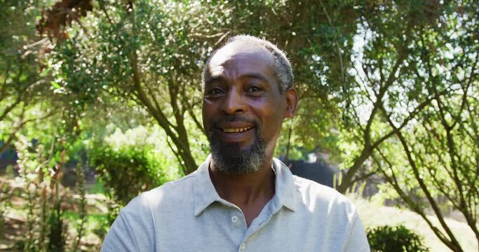 Portrait of senior african american man smiling in a sunny garden