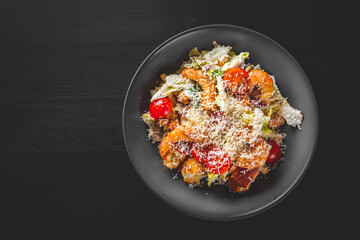 Seafood Caesar Salad with Shrimps, Salad Leaf, Croutons, Cherry Tomato and Parmesan Cheese in bowl