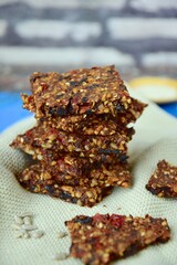 Seed crackers made from bell pepper, sun dried tomato, sunflower seed, sesame seed, hemp seed and flax seeds. Selective focus
