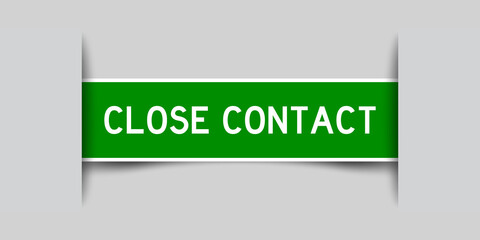 Label sticker green color in word close contact that inserted in gray background