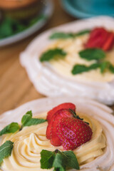 Meringue and whipped cream dessert layered with seasonal strawberry.