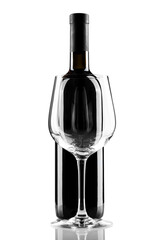 bottle of red wine without label and glass isolated on white background