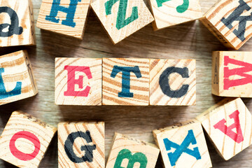 Alphabet letter block in word etc (abbreviation of et cetera) with another on wood background