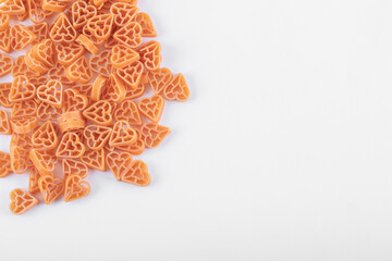 Bunch of raw pasta formed on white background