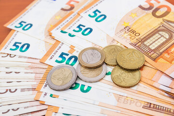 Fifty euro banknotes and coins.