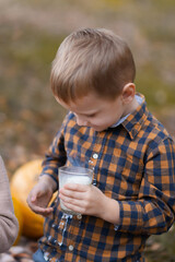The boy spilled milk while drinking in the park