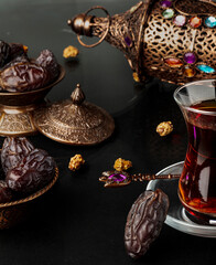 Ramadan concept with cup of tea and dried dates