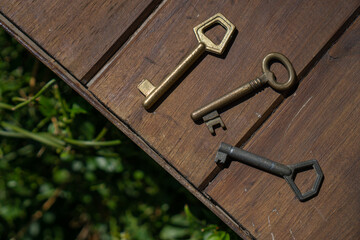 Set of old door keys on wood.