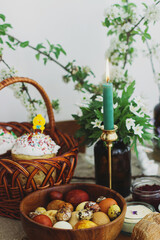 Traditional Easter food, homemade Easter bread,  easter eggs and spring flowers on rustic table
