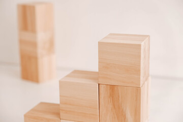 Stack wooden blocks from natural wood on a white background. Copy, empty space for text