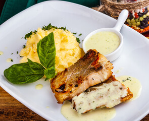 Fried fish with mashed potatoes on white plate
