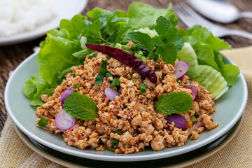 Laab gai or larb gai, spicy minced chicken breast salad, the healthy food served with fresh vegetables. This clean food in Isan Thai food style uses lean chicken meat that is good for diners’ health.