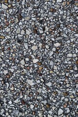 Asphalt background paved road cobblestone closeup abstract in vertical format.