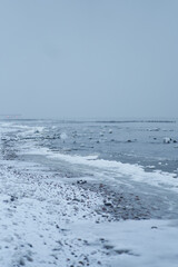 Snowy coast of the baltic sea. The sea is frozen in winter