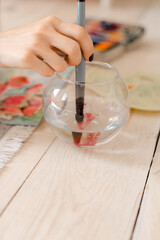 Portrait of a young woman painting at home